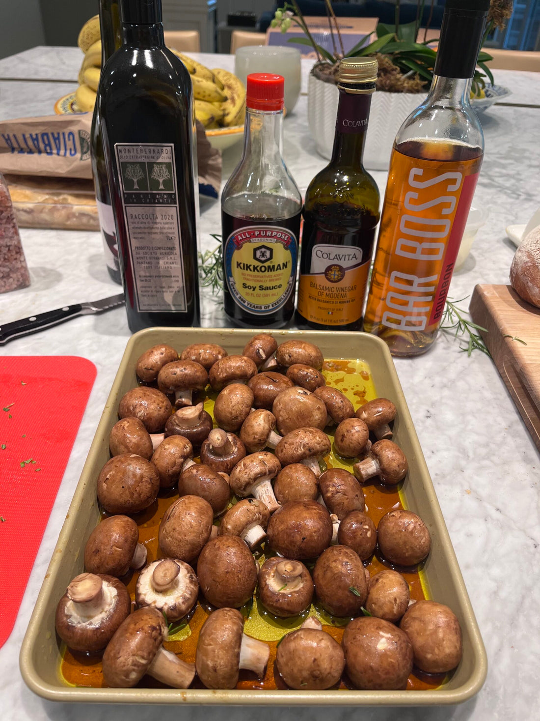 Mushrooms in a pan with ingredients behind them.