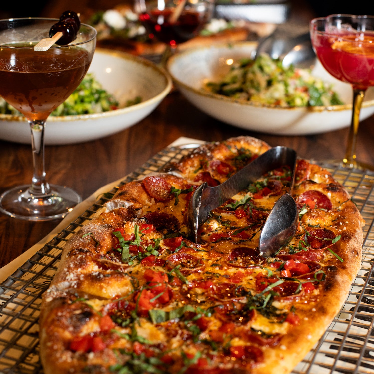 pizza with drinks and salads