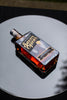 Bottle of Savor Spear whiskey on a reflective surface