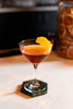 Cocktail with an orange twist on a marble surface