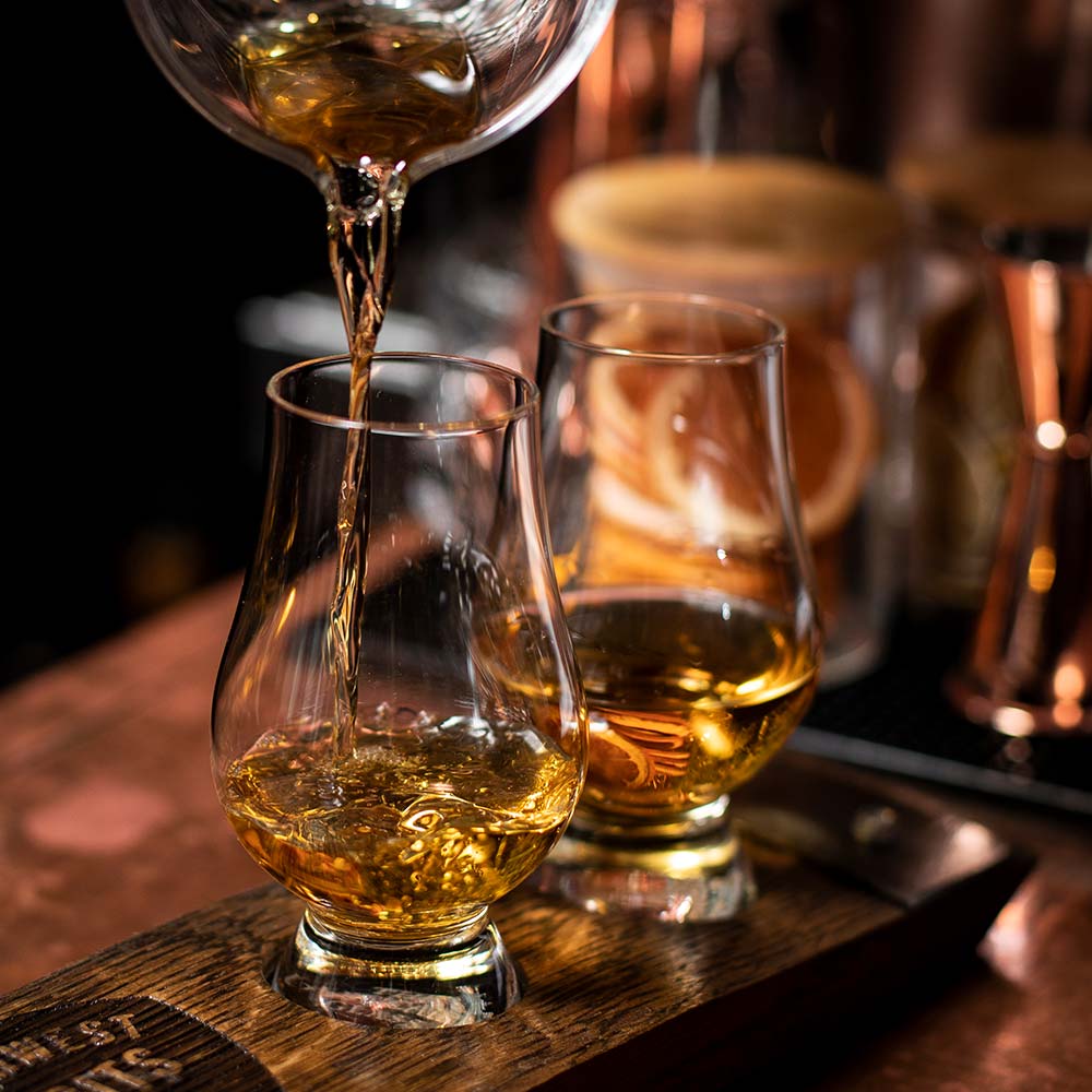 whiskey being poured into a glass